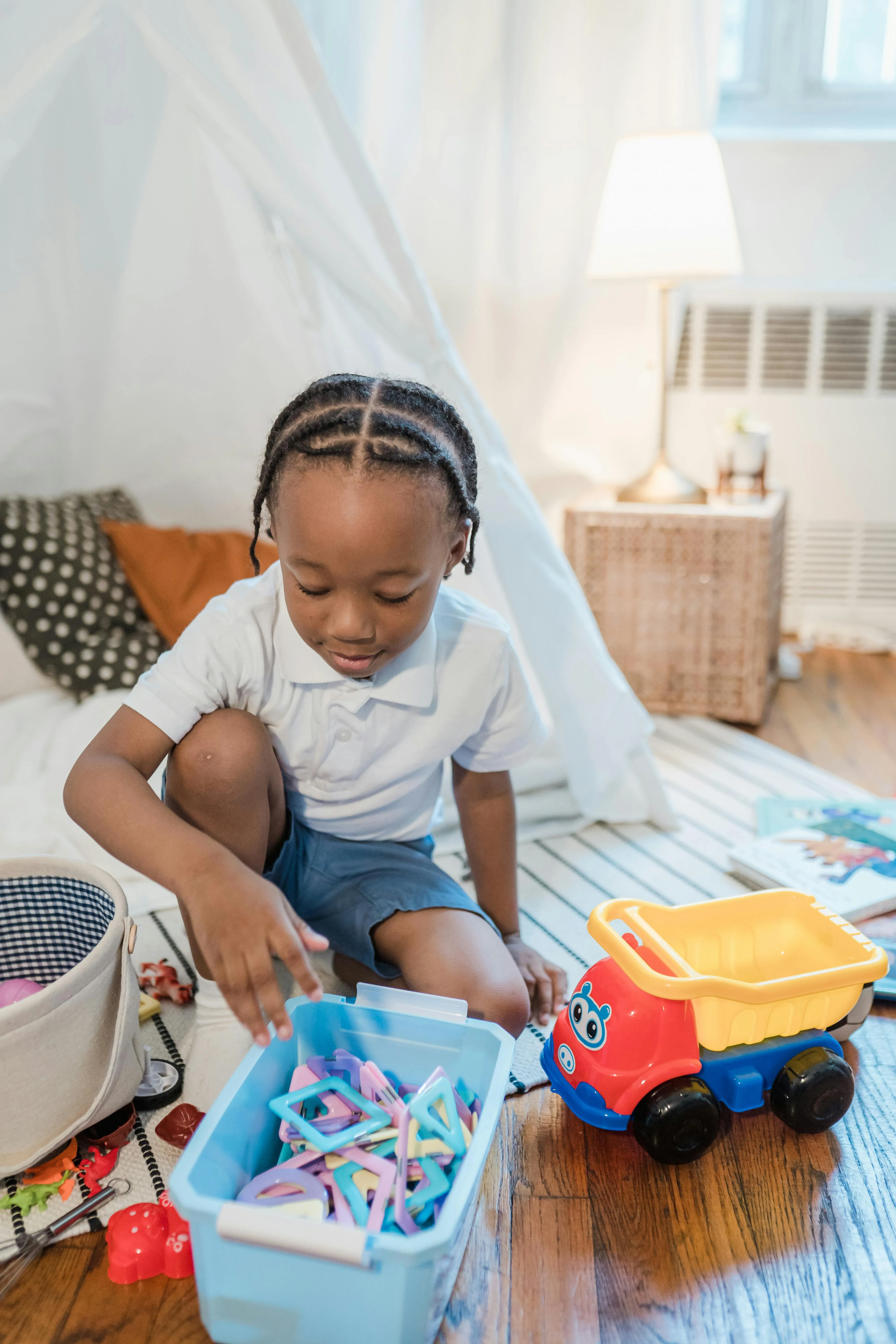 child picking up items in a living room