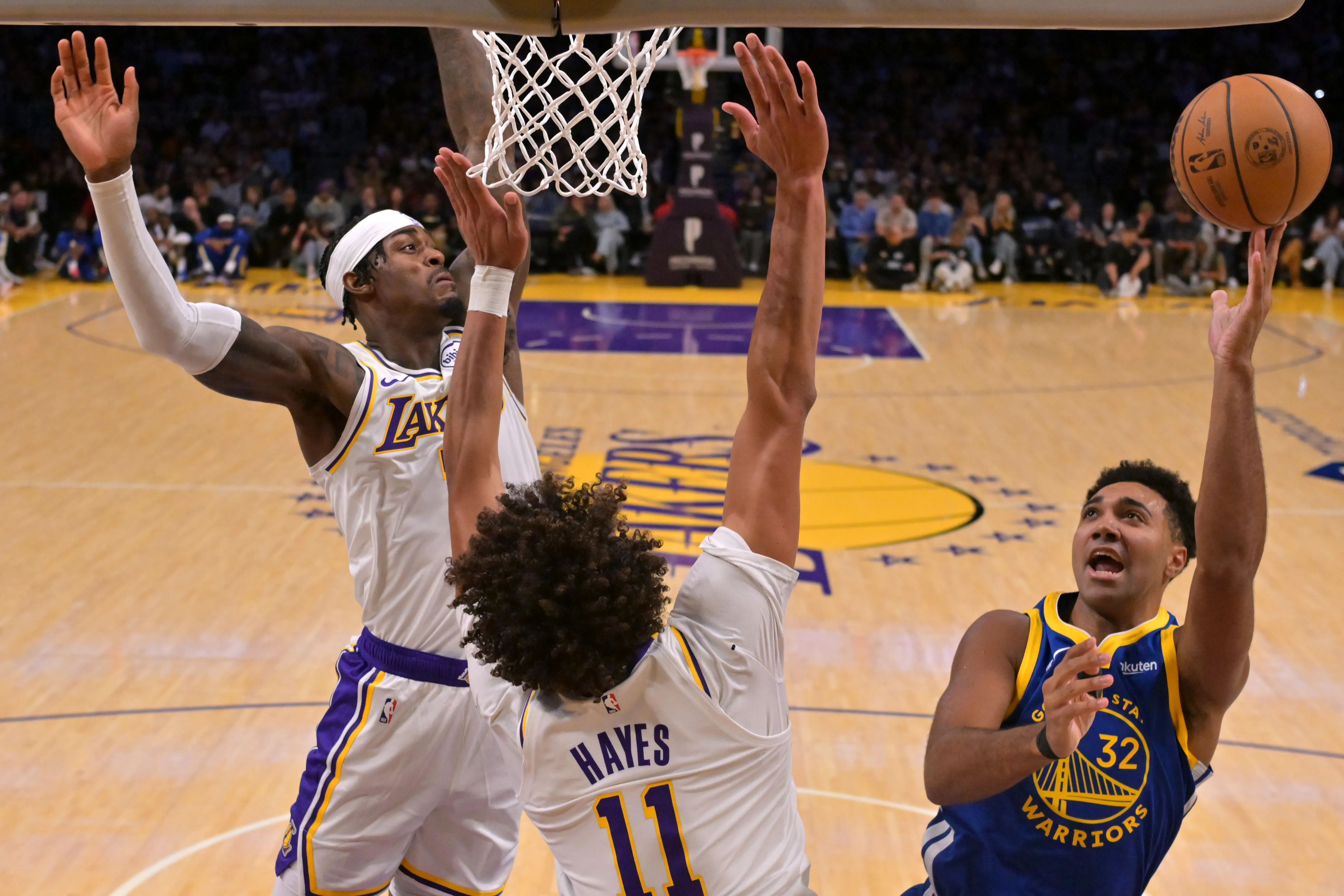 Oct 12, 2025; Los Angeles, California, USA; Los Angeles Lakers forward Jarred Vanderbilt (2) and center Jaxson Hayes (11) defend a shot by Golden State Warriors forward Trayce Jackson-Davis (32) during the first half at Crypto.com Arena.