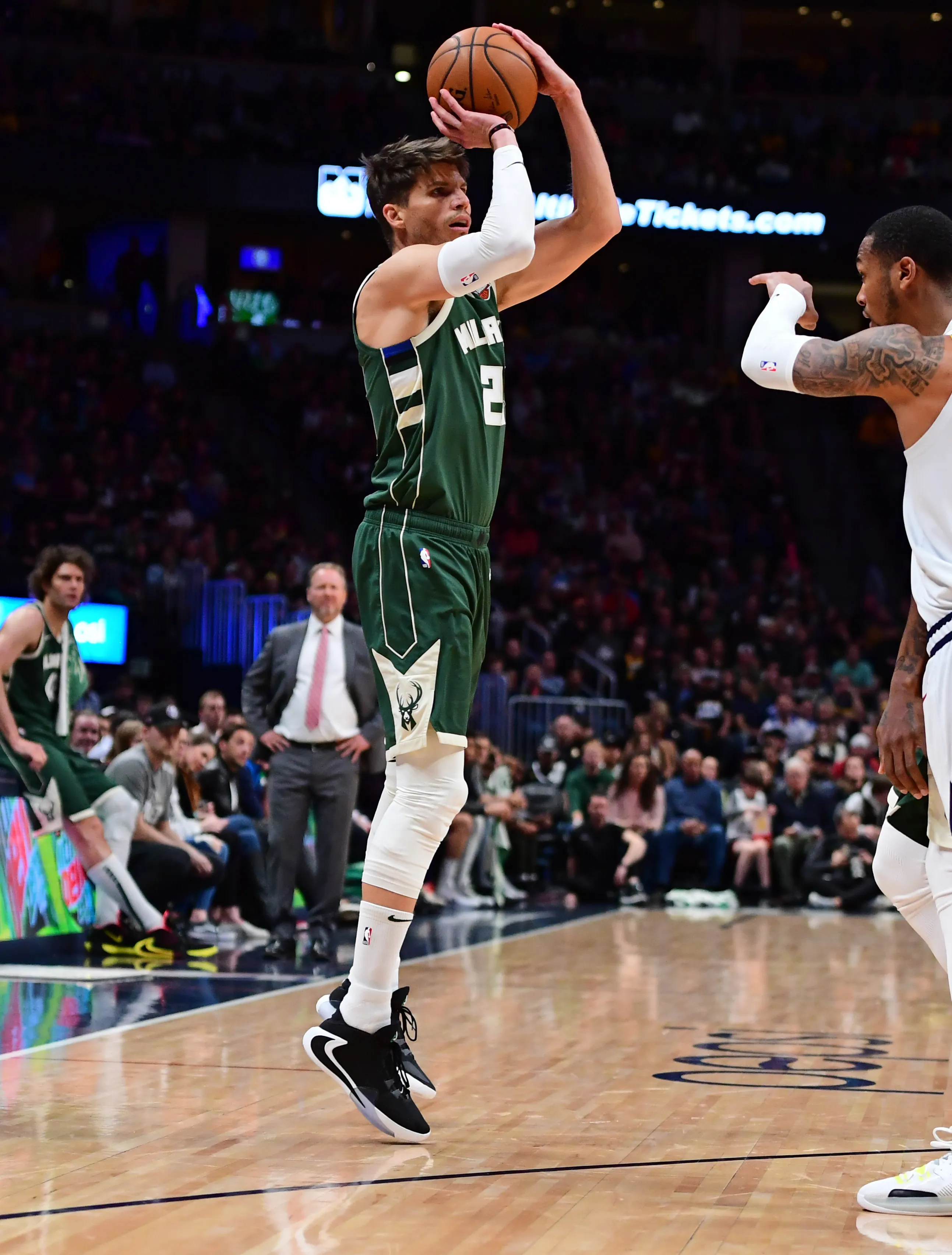 Mar 9, 2020; Denver, Colorado, USA; Milwaukee Bucks guard Kyle Korver (26) lines up a three point shot in the second quarter against the Denver Nuggets at the Pepsi Center.